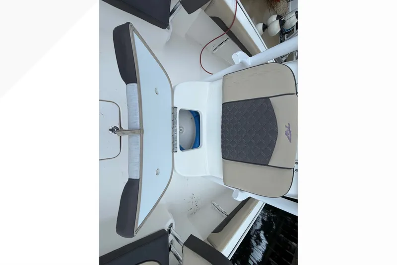 Slide: The Image of 2021 Tidewater 2500 Carolina Bay boat seat with storage compartment open. - 22