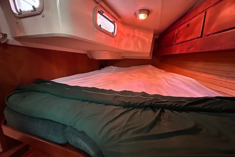 Slide: The Image of Cozy cabin interior of 2001 Sabre 402 sailboat with bed and wooden storage. - 24