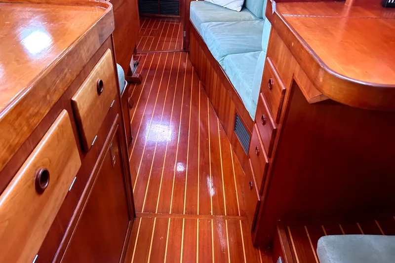 Slide: The Image of Interior of a 2001 Sabre 402 yacht with polished wood flooring and cabinetry. - 13