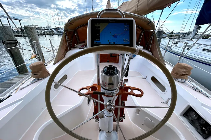 Slide: The Image of Cockpit of a 2001 Sabre 402 sailboat with navigation equipment and steering wheel. - 33