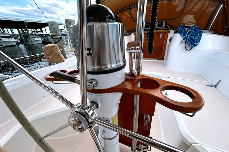Slide: The Image of Steering wheel and cockpit of a 2001 Sabre 402 sailboat, docked at a marina. - 34