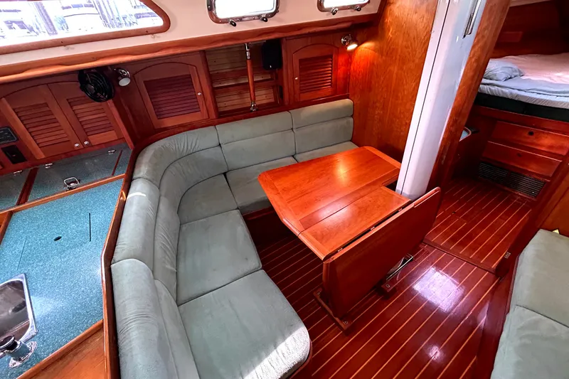 Slide: The Image of Luxurious interior of a 2001 Sabre 402 sailboat with wood finishes and cozy seating. - 5