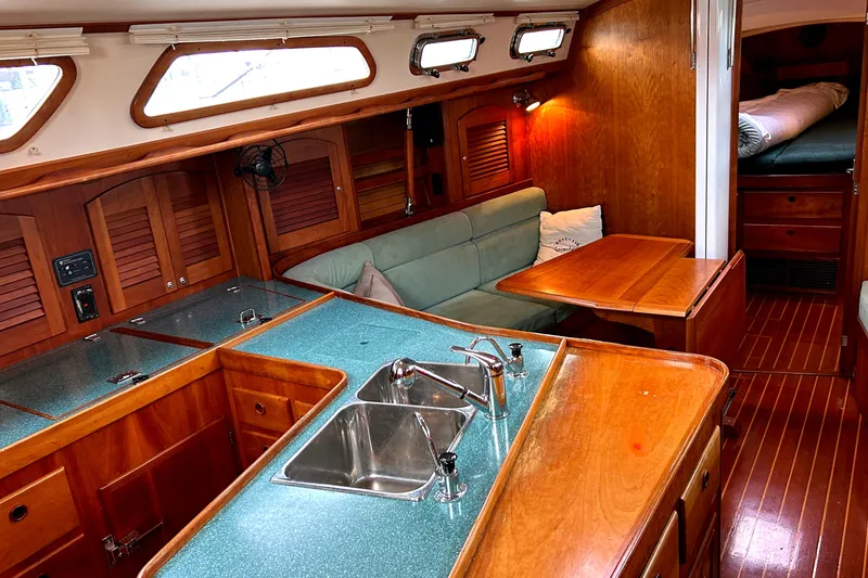 Slide: The Image of Interior of a 2001 Sabre 402 sailboat with wood finish and compact kitchen. - 11