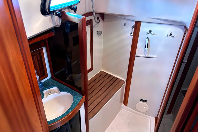 Slide: The Image of 2001 Sabre 402 yacht bathroom with wooden accents and compact sink. - 23