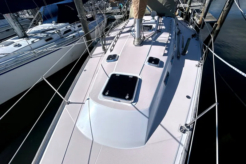 Slide: The Image of Sailboat deck of 2001 Sabre 402, docked with visible hatches and rigging. - 38