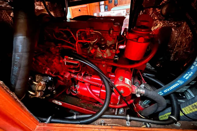 Slide: The Image of Engine compartment of a 2001 Sabre 402, showcasing red mechanical components and hoses. - 28