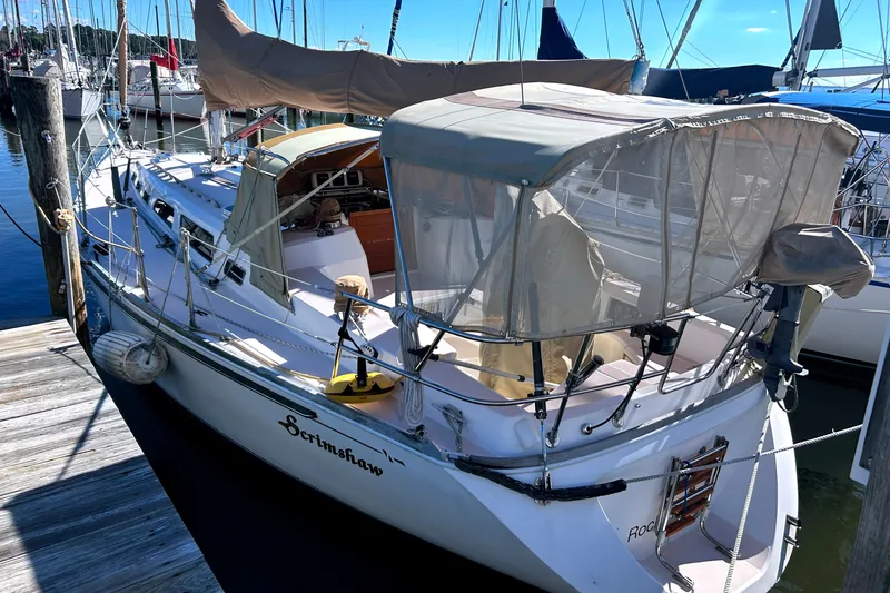Slide: The Image of 2001 Sabre 402 sailboat docked, featuring a covered cockpit and sleek design. - 4