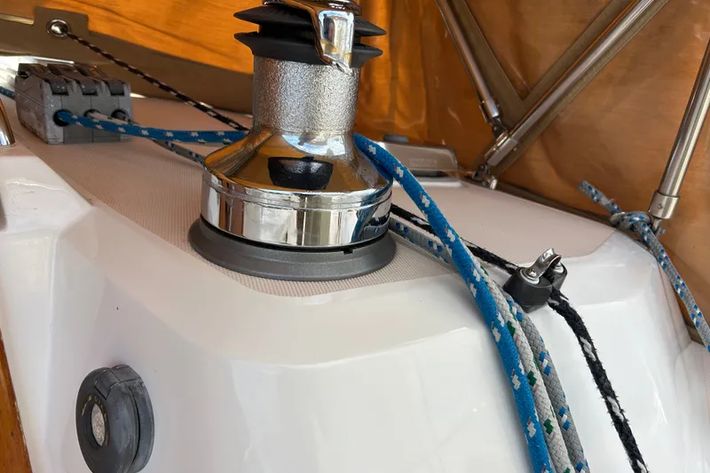 Slide: The Image of Close-up of a Sabre 402 sailboat winch with ropes, showcasing nautical equipment. - 31