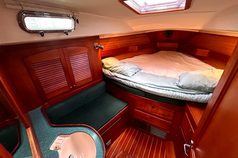 Slide: The Image of Cozy cabin interior of 2001 Sabre 402 sailboat with wood finish and comfortable bedding. - 17