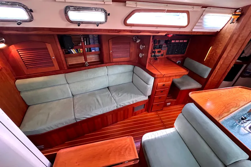 Slide: The Image of Interior of a 2001 Sabre 402 sailboat with wooden cabinetry and cushioned seating. - 7