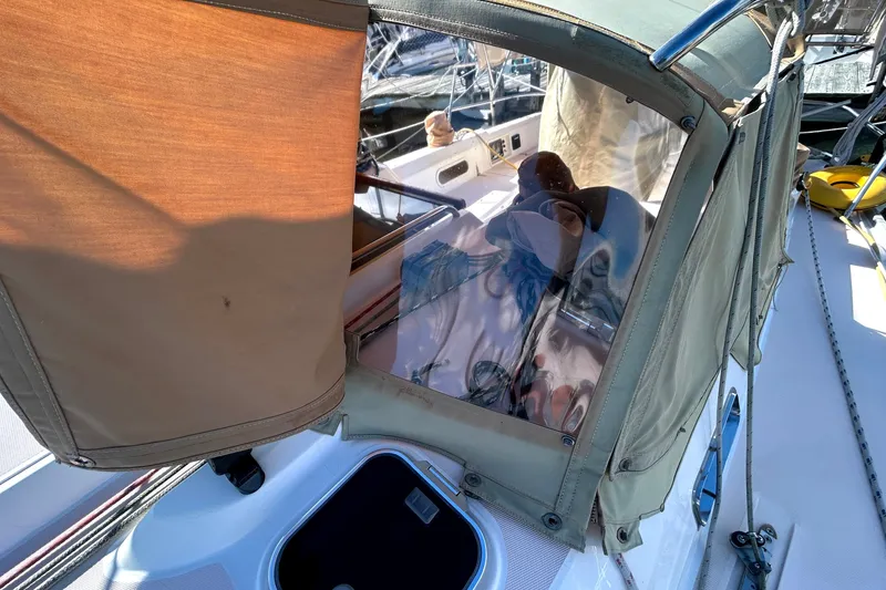 Slide: The Image of 2001 Sabre 402 sailboat cockpit with protective canvas cover and visible ropes. - 40