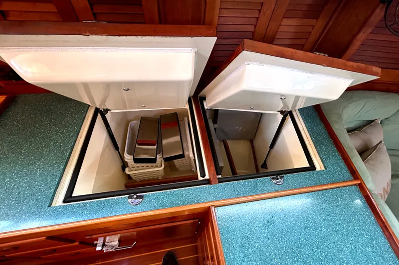 Slide: The Image of Open storage compartments on a 2001 Sabre 402 yacht with turquoise countertops. - 27