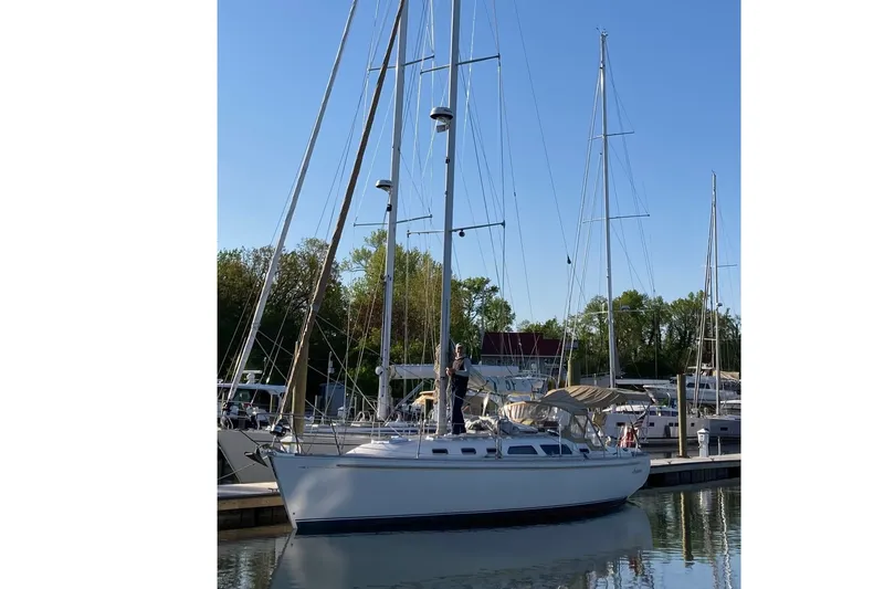 Slide: The Image of Sailboat Sabre 402, 2001 model, docked at marina under clear blue sky. - 2
