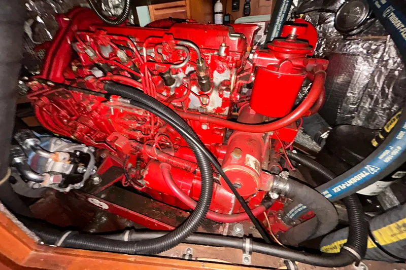 Slide: The Image of Red engine inside a 2001 Sabre 402 boat, showcasing intricate wiring and components. - 29