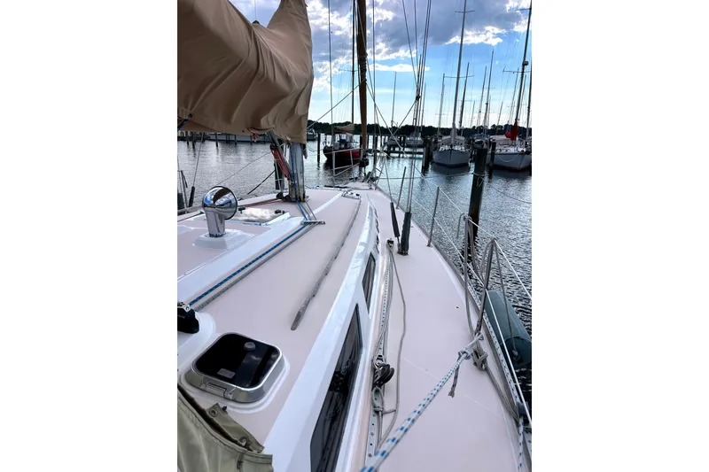 Slide: The Image of 2001 Sabre 402 sailboat docked at marina, showcasing deck and rigging. - 1