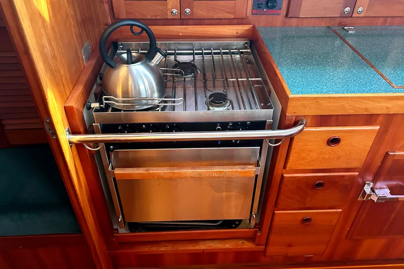 Slide: The Image of Wooden boat kitchen with stove, kettle, and storage, Sabre 402, 2001 model. - 14