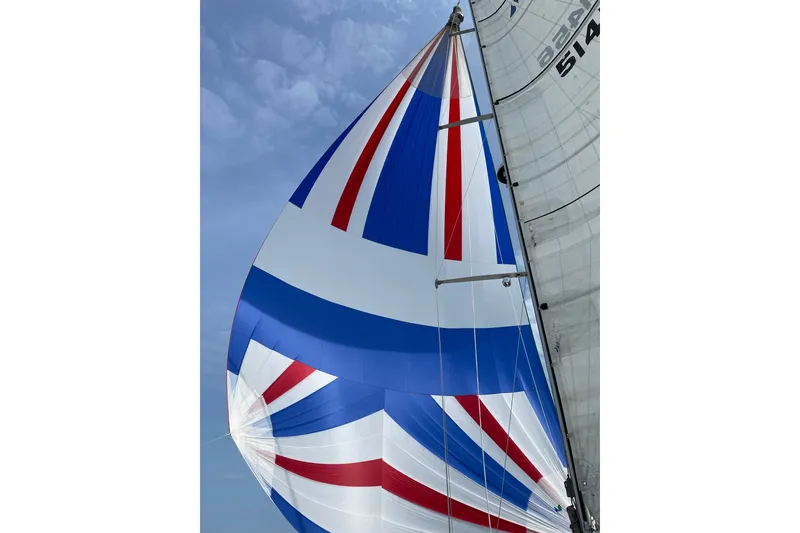 Slide: The Image of Colorful sail of a 2001 Sabre 402 yacht against a clear sky. - 37