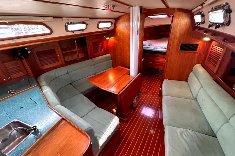 Slide: The Image of Luxurious interior of a 2001 Sabre 402 yacht with wood finishes and cozy seating. - 6