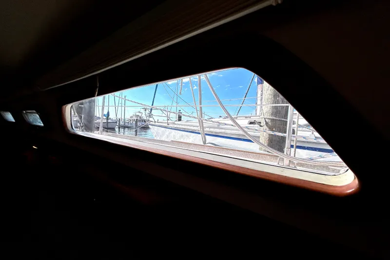 Slide: The Image of View from inside a 2001 Sabre 402 sailboat, showing marina and blue sky through window. - 19
