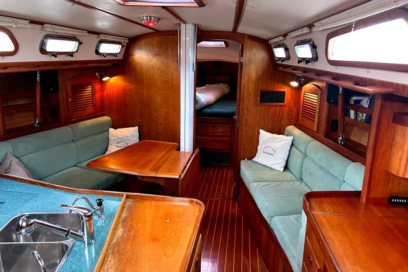 Slide: The Image of Luxurious 2001 Sabre 402 yacht interior with wood finish, cozy seating, and modern amenities. - 8