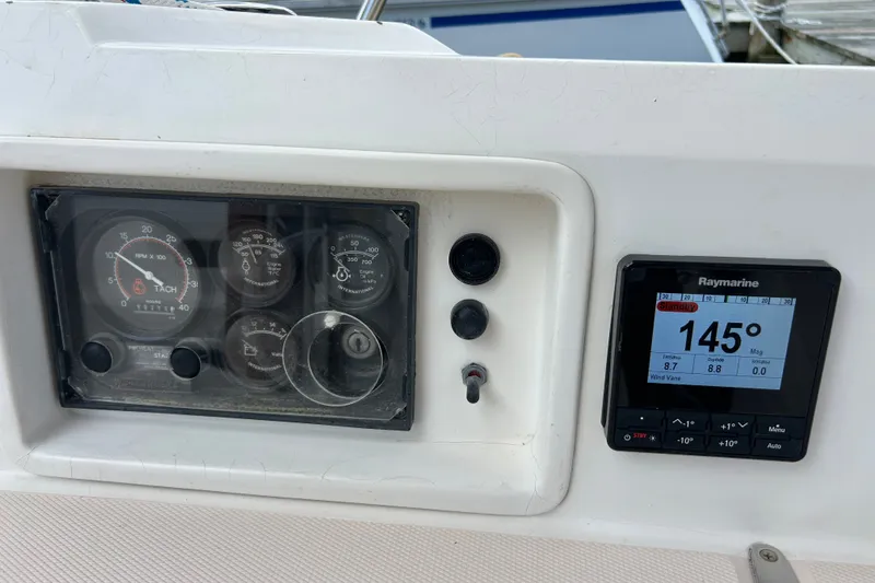 Slide: The Image of Control panel of a 2001 Sabre 402 boat with Raymarine display showing 145 degrees. - 32