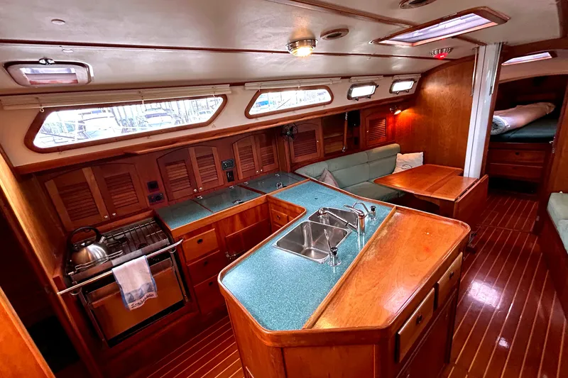 Slide: The Image of Luxurious 2001 Sabre 402 yacht interior with wood finish and modern kitchen amenities. - 10