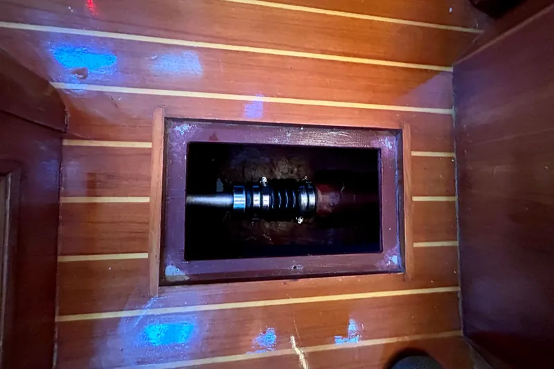 Slide: The Image of Wooden floor panel with exposed mechanical component on a 2001 Sabre 402 boat. - 30