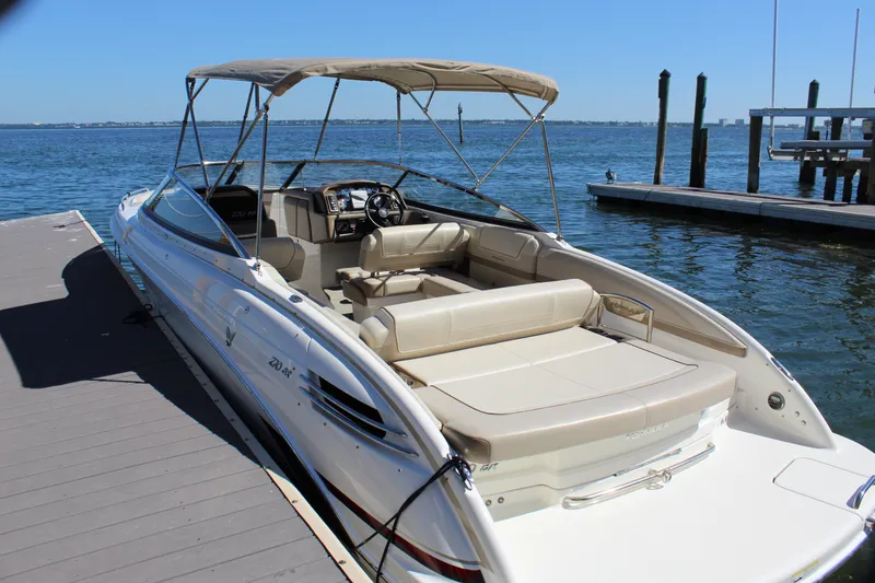 Slide: The Image of 2015 Formula 270 Bowrider docked, featuring spacious seating and canopy, on a sunny day. - 20