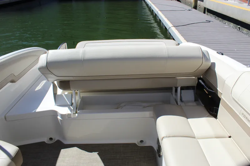 Slide: The Image of 2015 Formula 270 Bowrider boat interior with beige seating near dock. - 38