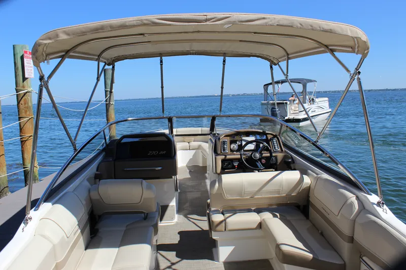 Slide: The Image of 2015 Formula 270 Bowrider boat with canopy, docked on a sunny day. - 24
