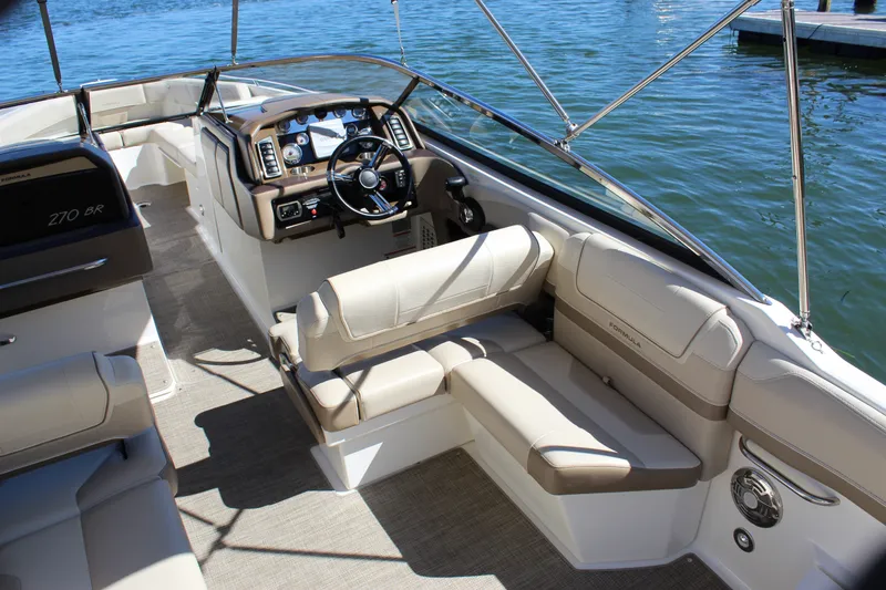 Slide: The Image of Interior of a 2015 Formula 270 Bowrider boat with beige seating and steering console. - 25