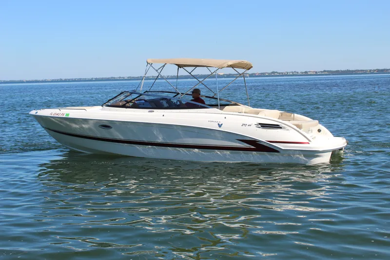 Slide: The Image of 2015 Formula 270 Bowrider boat cruising on calm waters under a clear blue sky. - 2