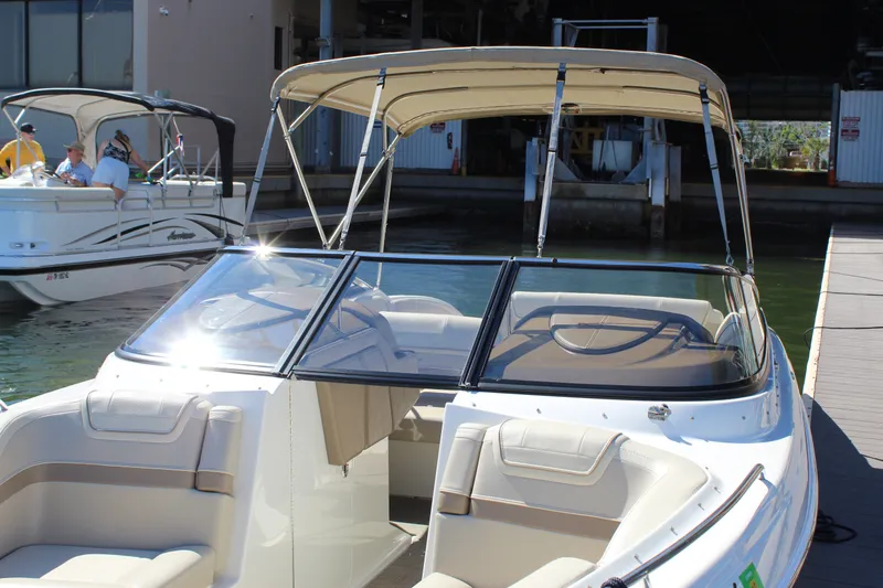 Slide: The Image of 2015 Formula 270 Bowrider boat docked with beige seating and canopy. - 19