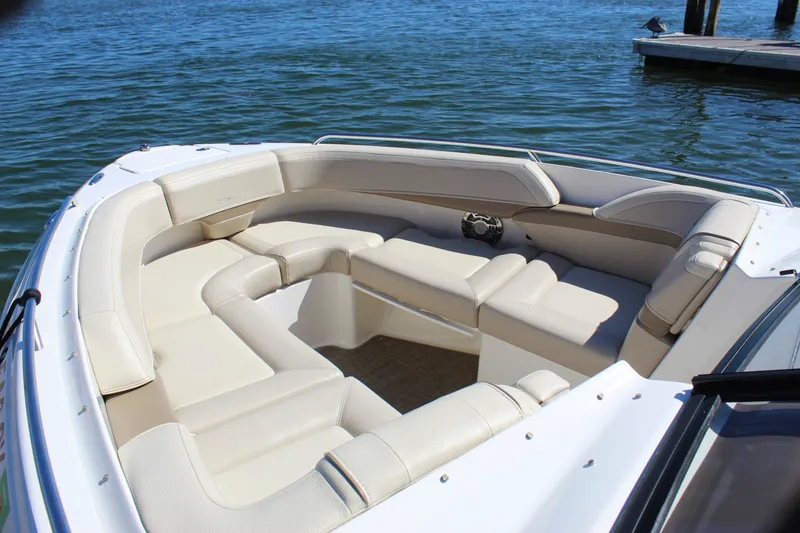 Slide: The Image of Luxurious seating on a 2015 Formula 270 Bowrider boat, docked by the water. - 16