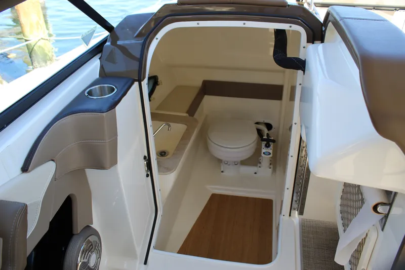 Slide: The Image of Interior of 2015 Formula 270 Bowrider boat featuring a compact marine toilet. - 43