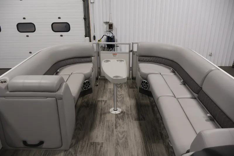 Slide: The Image of 2025 Ranger Reata 220C pontoon boat interior with plush seating and modern design. - 11