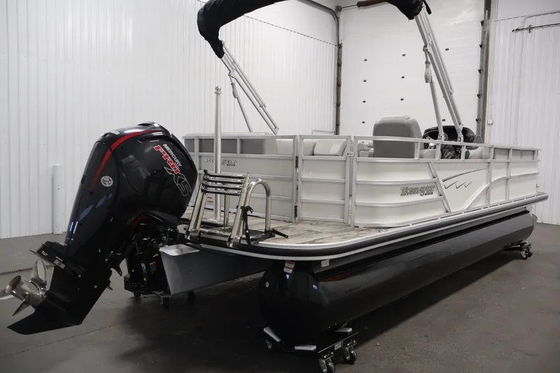 Slide: The Image of 2025 Ranger Reata 220C pontoon boat with Mercury engine in a garage setting. - 5