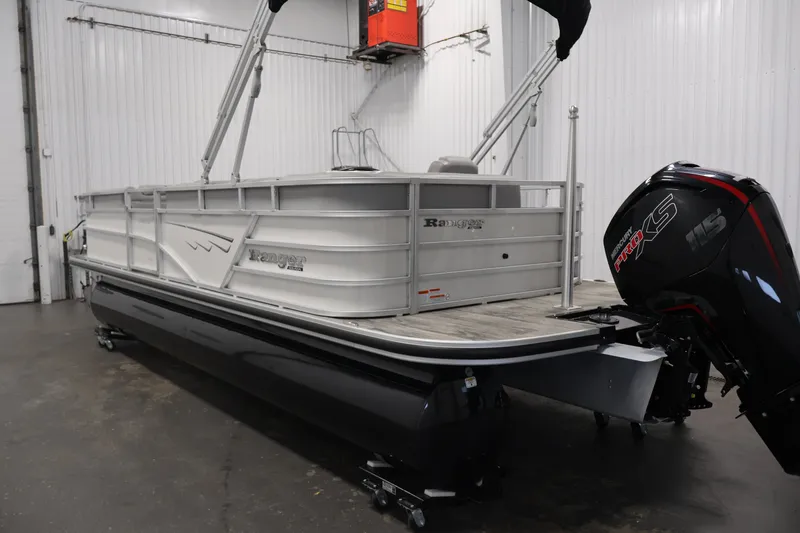 Slide: The Image of 2025 Ranger Reata 220C pontoon boat with Mercury Pro XS engine in a showroom. - 7