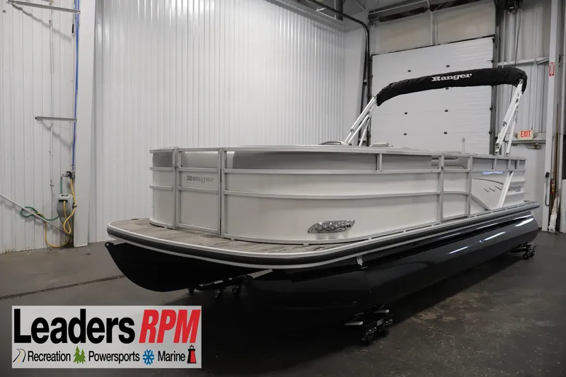 Slide: The Image of 2025 Ranger Reata 220C pontoon boat in showroom, Leaders RPM logo visible. - 1
