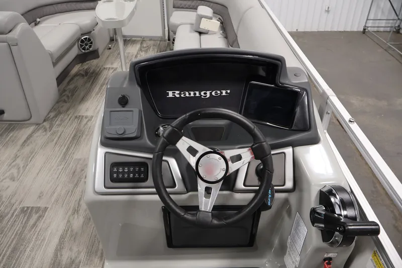 Slide: The Image of 2025 Ranger Reata 220C boat dashboard with steering wheel and controls. - 23