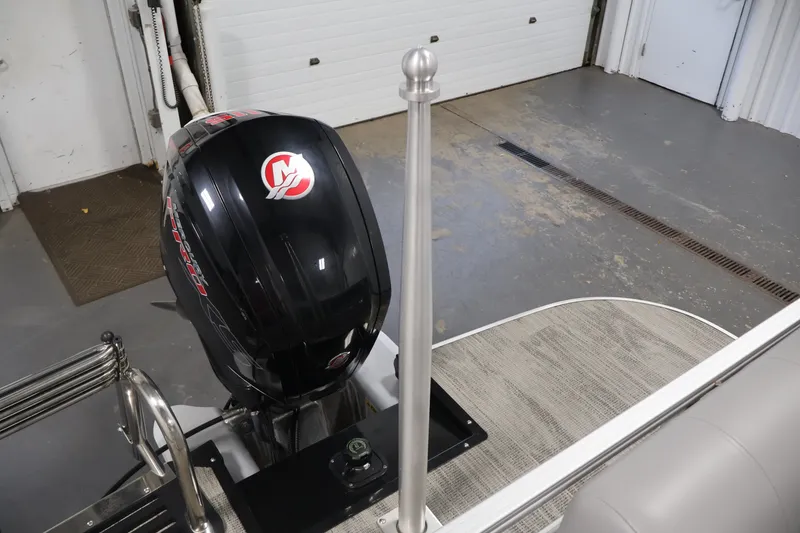 Slide: The Image of 2025 Ranger Reata 220C boat with powerful outboard motor in a garage setting. - 35