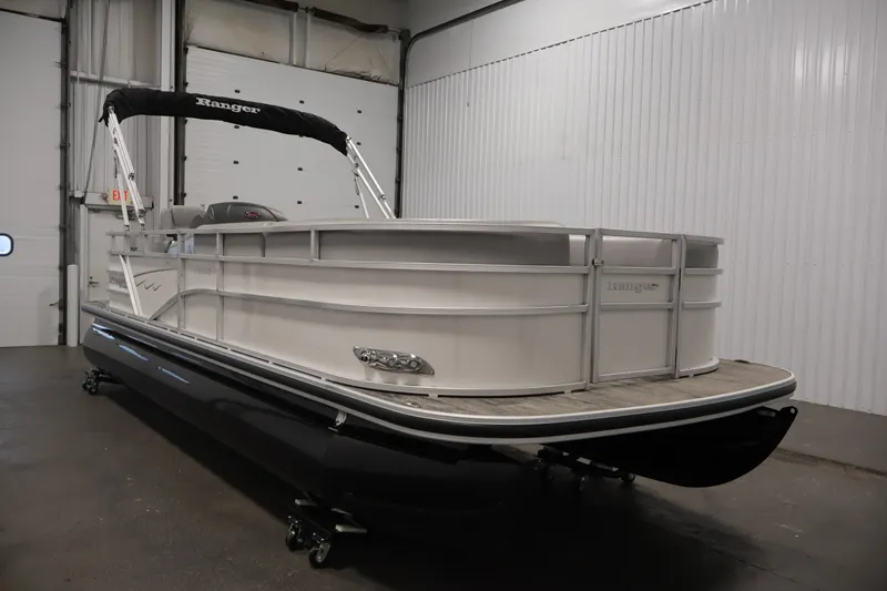 The Image of 2025 Ranger Reata 220C pontoon boat in a showroom, featuring sleek design and modern amenities. - 0
