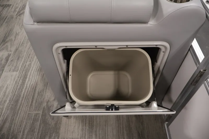 Slide: The Image of 2025 Ranger Reata 220C interior storage compartment with open lid, showcasing spacious design. - 31