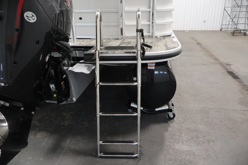 Slide: The Image of 2025 Ranger Reata 220C boat with ladder and motor in a garage setting. - 36