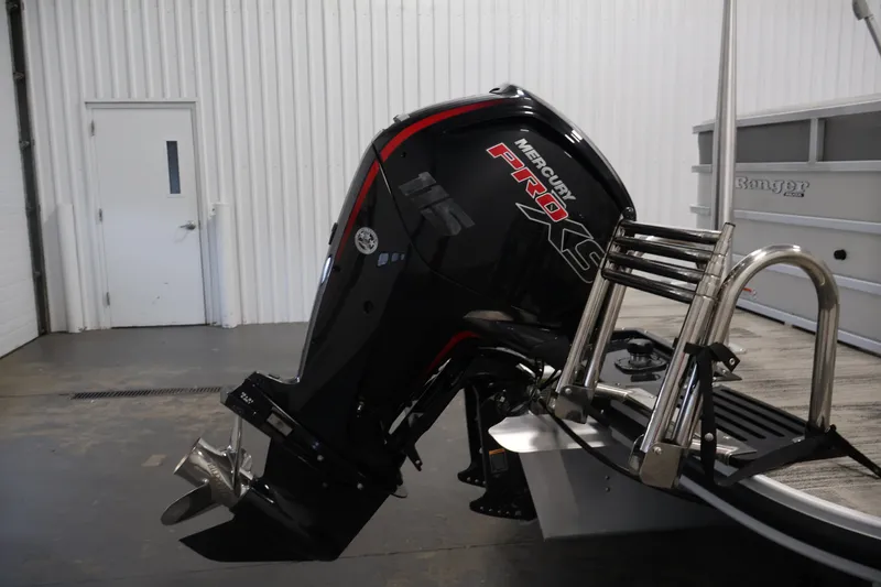 Slide: The Image of 2025 Ranger Reata 220C with Mercury Pro XS outboard motor in a garage setting. - 37