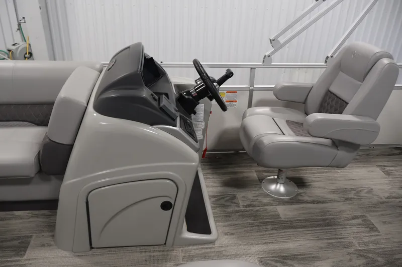 Slide: The Image of 2025 Ranger Reata 220C boat interior with modern steering console and comfortable seating. - 21