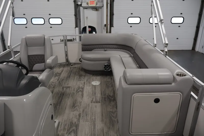 Slide: The Image of 2025 Ranger Reata 220C pontoon boat interior with plush seating and modern design. - 30