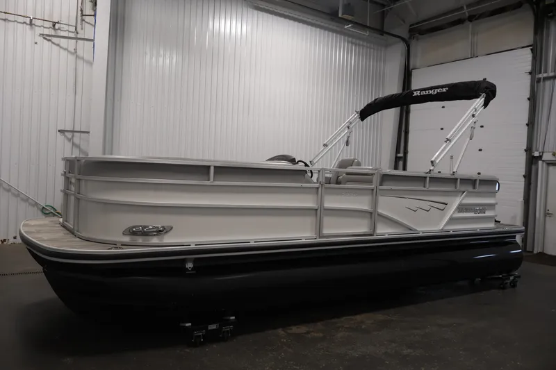 Slide: The Image of 2025 Ranger Reata 220C pontoon boat in a garage setting. - 8
