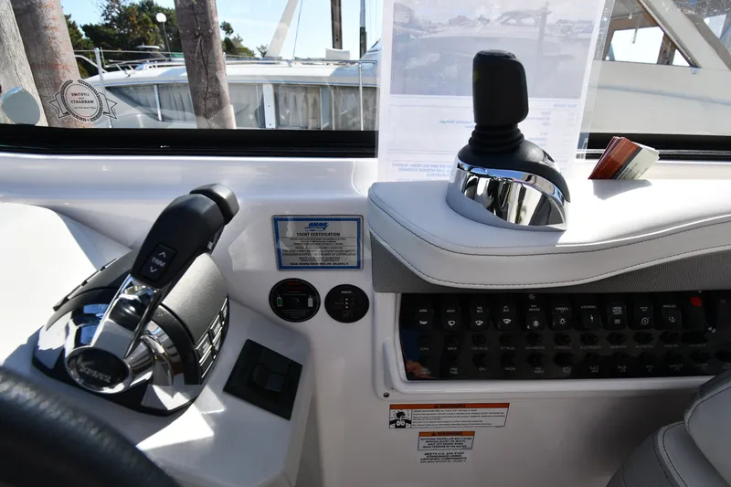 Slide: The Image of Control panel of a 2021 Regal 35 Sport Coupe boat with joystick and throttle. - 13