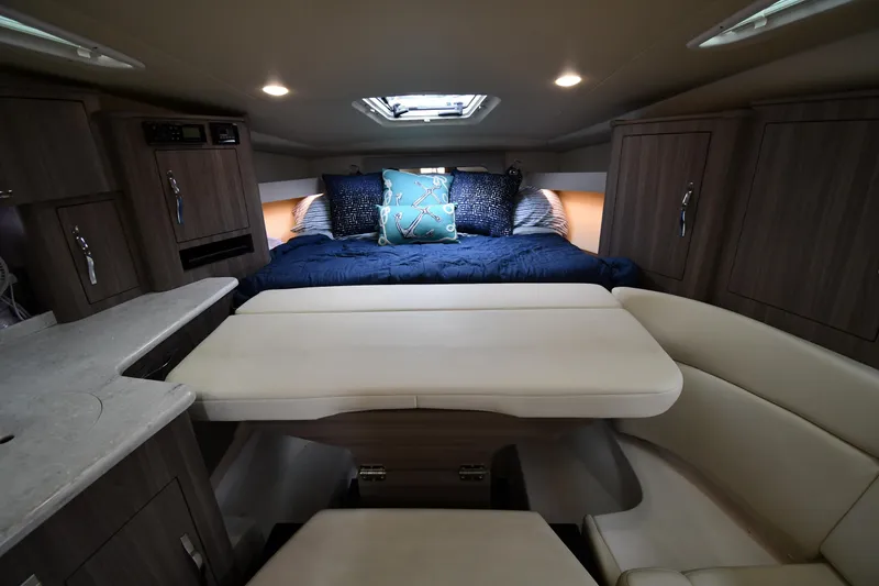 Slide: The Image of 2021 Regal 35 Sport Coupe interior with cozy bed, dining area, and modern cabinetry. - 28